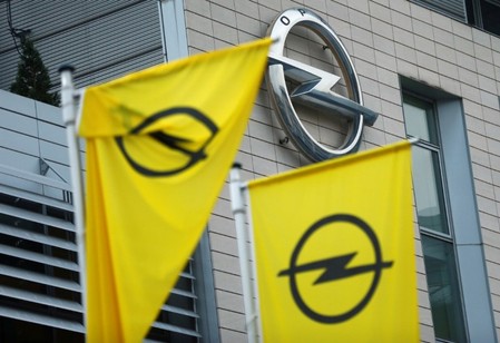 FILE PHOTO: Flags with the Opel logo are seen at the Opel headquarters in Ruesselsheim