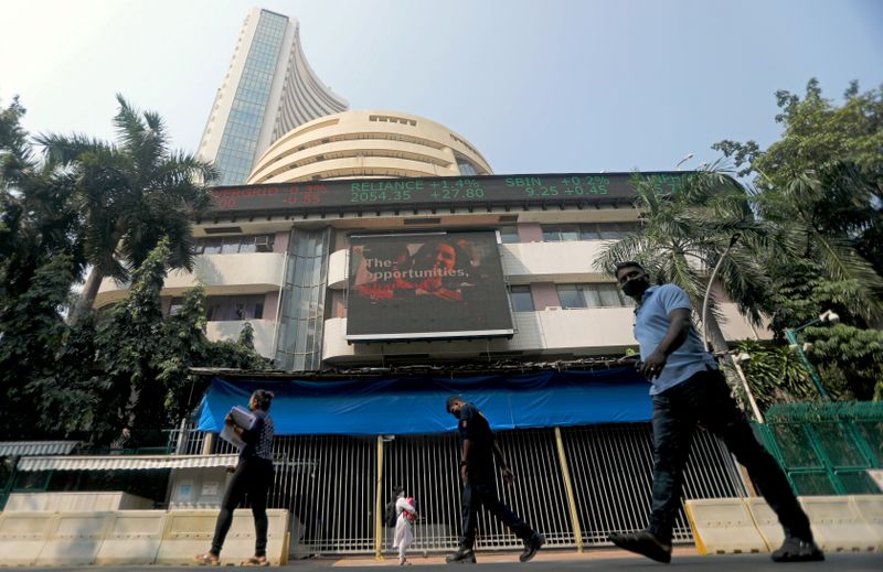 FILE PHOTO: People walk past the Bombay Stock Exchange (BSE) building in Mumbai
