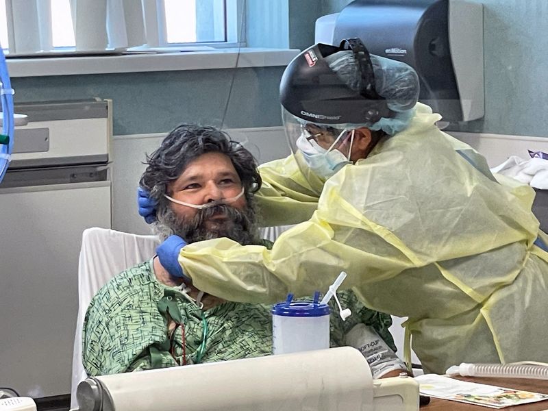 FILE PHOTO: A COVID-19 patient is treated in the ICU at Providence St Joseph Hospital in Orange, California