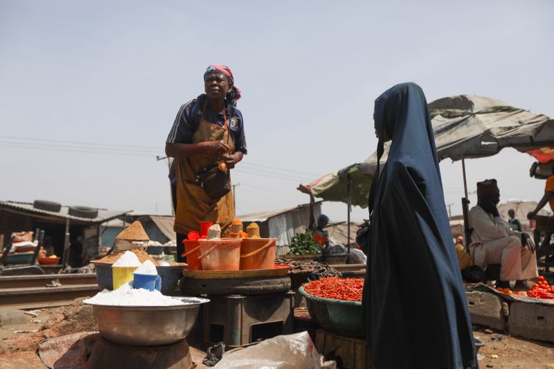 A woman sells spices at a market in Kaduna