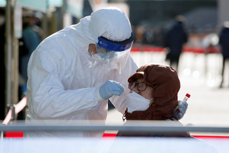 A person undergoes coronavirus disease (COVID-19) test at a testing site which is temporarily set up at a railway station in Seoul
