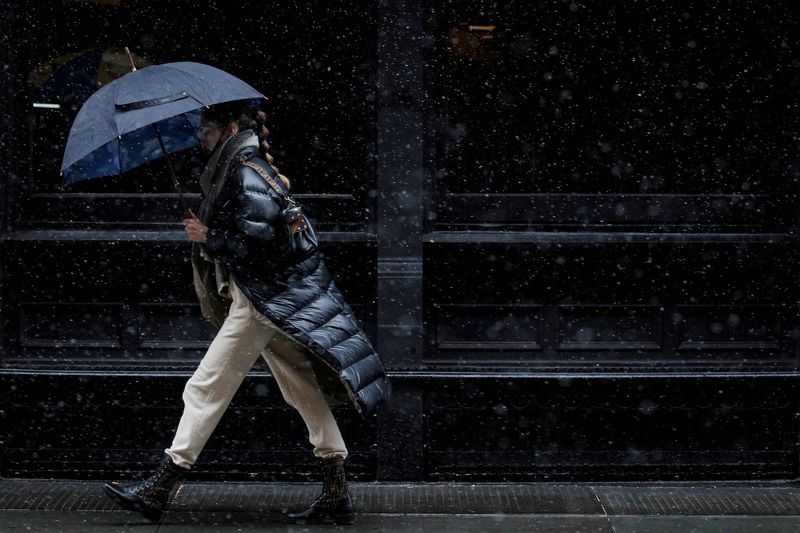 FILE PHOTO: A woman walks in the snow in the Manhattan borough of New York