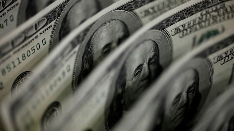 Dollar jumps after Fed official's taper talk stirs markets