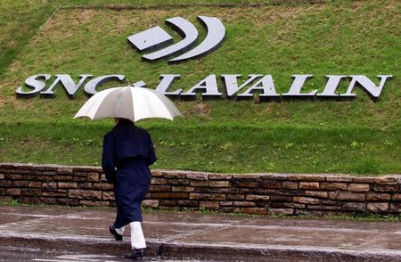 A pedestrian walks past the SNC-Lavalin Group Inc., headquarters in Montreal