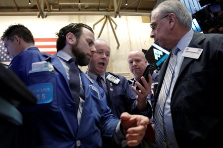 Traders work on the floor of the NYSE 