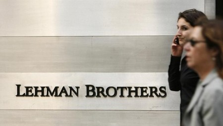 Pedestrians walk past a Lehman Brothers sign in New York