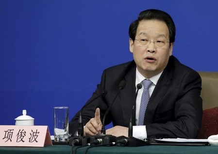 Xiang Junbo, chairman of CIRC, answers a question at a news conference in Beijing