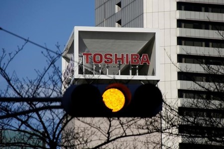 Logo of Toshiba Corp is seen behind a traffic signal at its headquarters in Tokyo