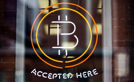 FILE PHOTO - A Bitcoin sign is seen in a window in Toronto