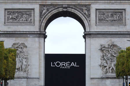 The logo of French cosmetics group L'Oreal is seen in front of the Arc de Triomphe during a public event in Paris