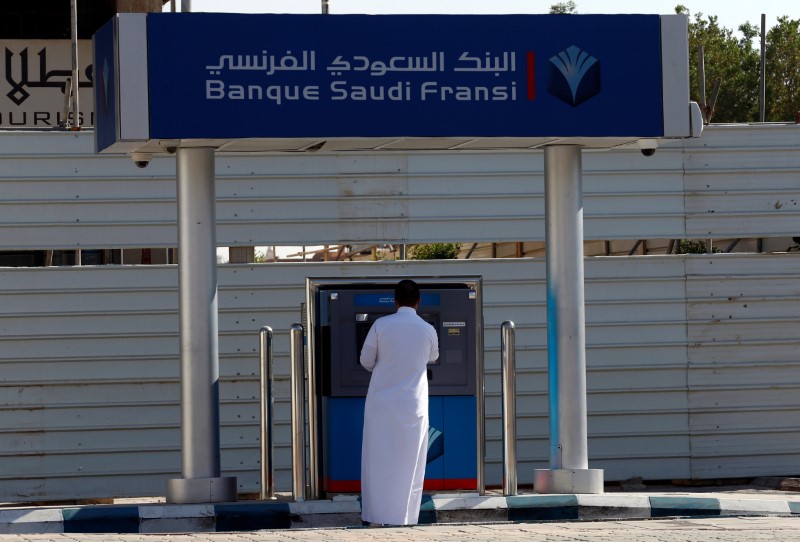 A man withdraws money from an ATM outside Banque Saudi Fransi in Riyadh