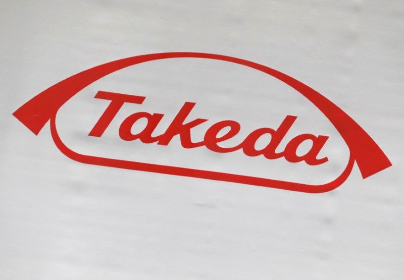 FILE PHOTO: The logo of Takeda Pharmaceutical Co. is displayed at the company's news conference venue in Tokyo