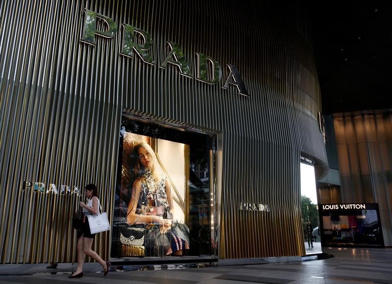 FILE PHOTO: A shopper passes a Prada shop at Orchard Road in Singapore