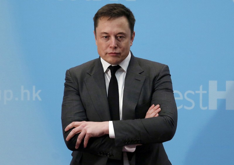 FILE PHOTO: FILE PHOTO: Tesla Chief Executive Elon Musk stands on the podium as he attends a forum on startups in Hong Kong