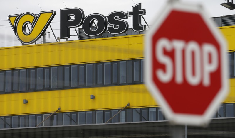 The logo of Austrian Post is pictured behind a traffic sign on the roof of Austrian Post logistics centre in Vienna