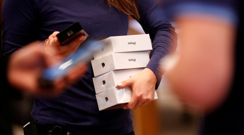 FILE PHOTO: Apple staff hold iPhone X packages at the Apple Store in Berlin