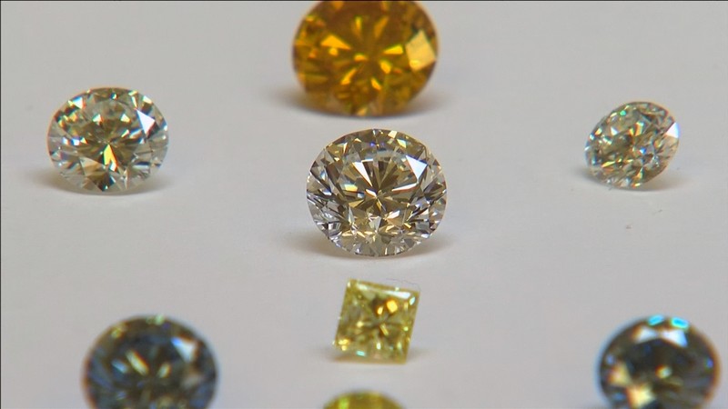 FILE PHOTO: A still image from video shows coloured synthetic diamonds on display at De Beers' International Institute of Diamond Grading and Research in Maidenhead