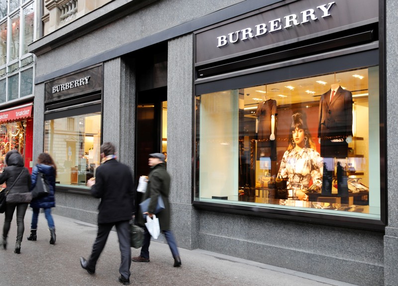 People walk past a store of British luxury brand Burberry in Zurich