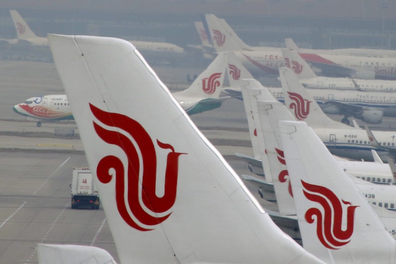 Air China planes are parked on the tarmac of Beijing Capital International Airport in Beijing