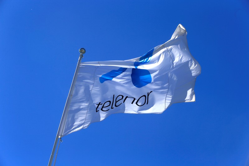 FILE PHOTO: Telenor flag flutters next to the company's headquarters in Fornebu