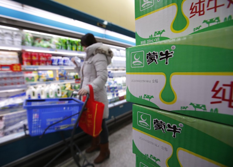 Cartons of Mengniu's milk products are placed at a supermarket in Beijing