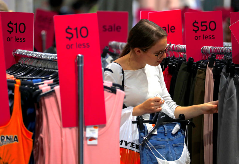 FILE PHOTO: FILE PHOTO - A shopper holds items and looks at others on sale at a clothing retail store in central Sydney, Australia
