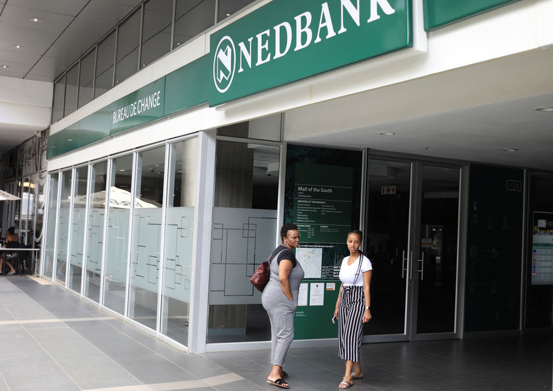 Customers look on outside Nedbank, after the bank closed due to load shedding, at the Mall of the South in Johannesburg
