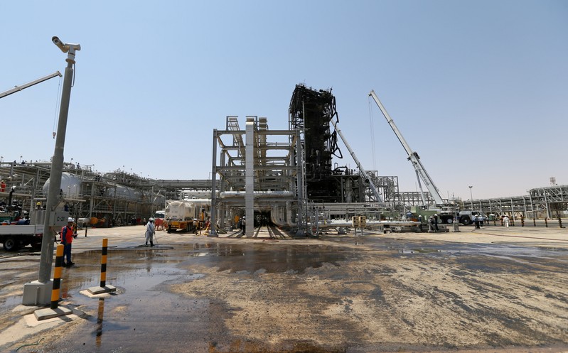 FILE PHOTO: Workers are seen at the damaged site of Saudi Aramco oil facility in Khurais