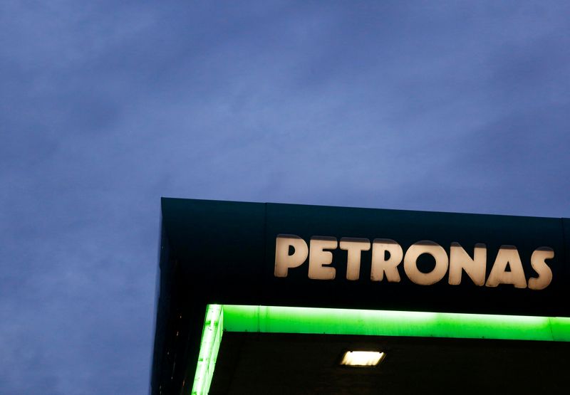 FILE PHOTO: A logo of a Petronas fuel station is seen against a darkening sky in Kuala Lumpur