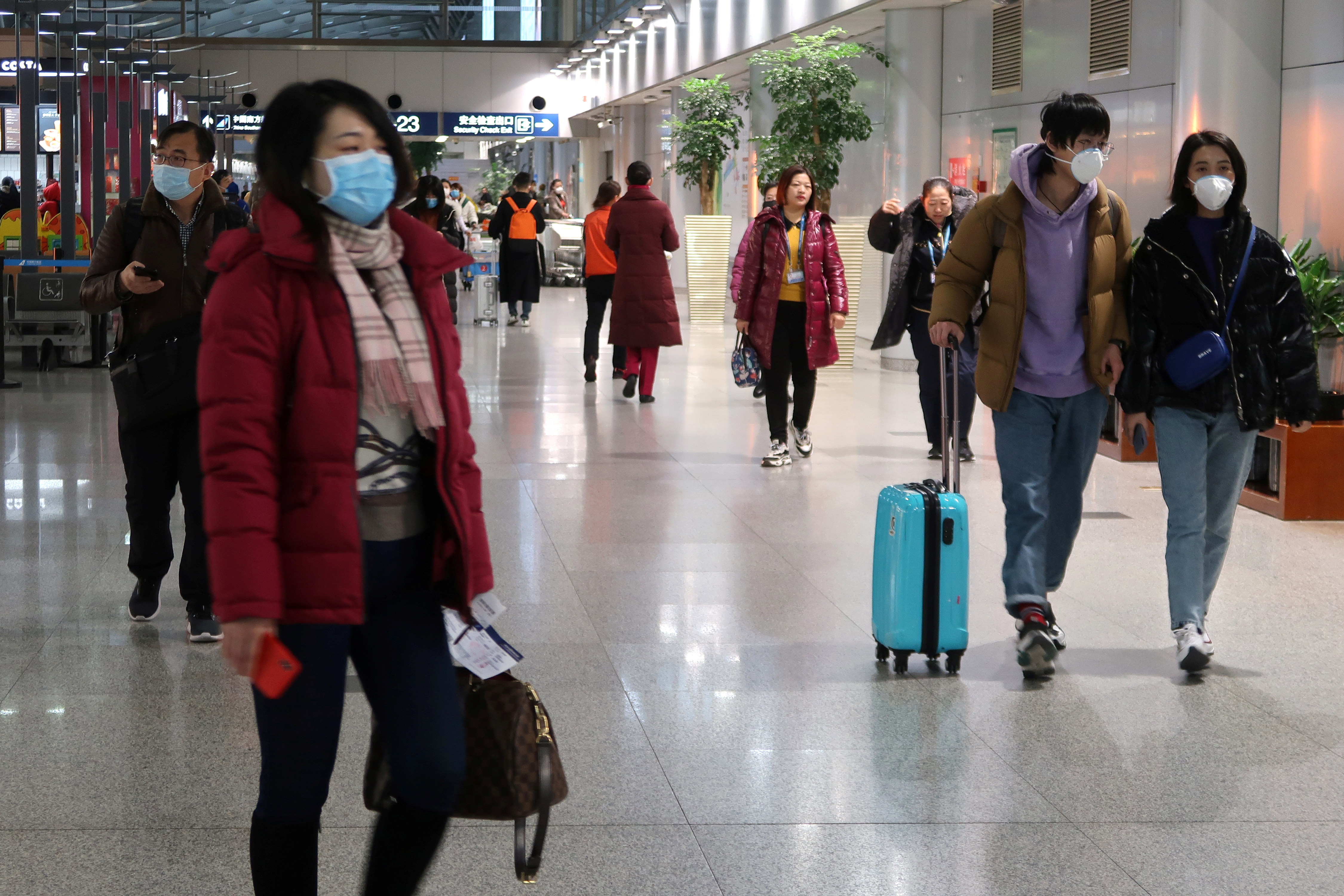 Passengers wearing masks are seen at the terminal hall of the Beijing Capital International Airport, in Beijing