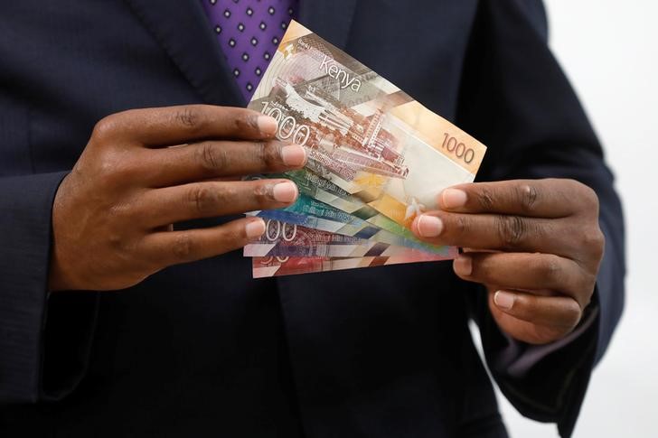 Kenya Central Bank Governor Patrick Njoroge displays the newly designed Kenyan shilling bank notes during a news conference at the Central Bank in Nairobi