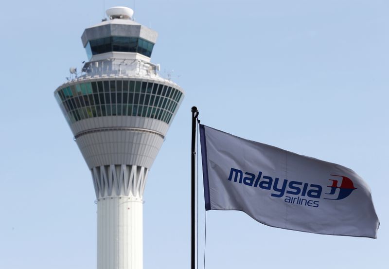FILE PHOTO:  Malaysian Airlines flag flies in front of the traffic control tower at Kuala Lumpur International Airport in Sepang
