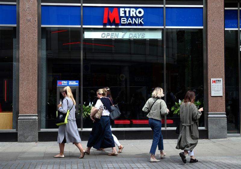 FILE PHOTO: People walk past a Metro Bank in London