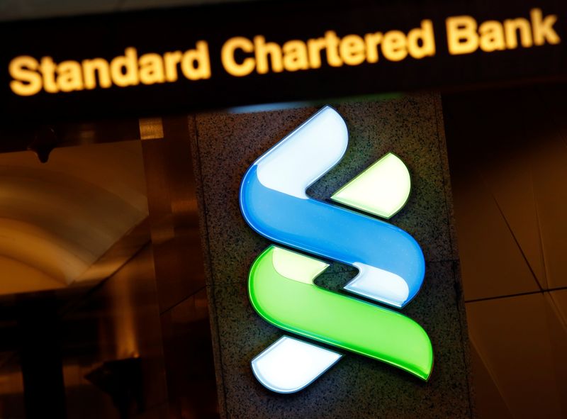 FILE PHOTO: A logo of Standard Chartered is displayed at its main branch in Hong Kong