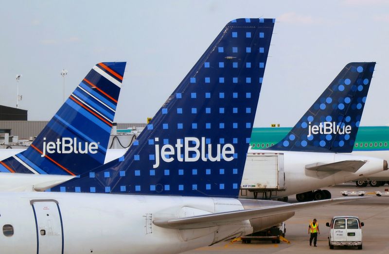 FILE PHOTO: FILE PHOTO: JetBlue Airways aircrafts are pictured at departure gates at John F. Kennedy International Airport in New York