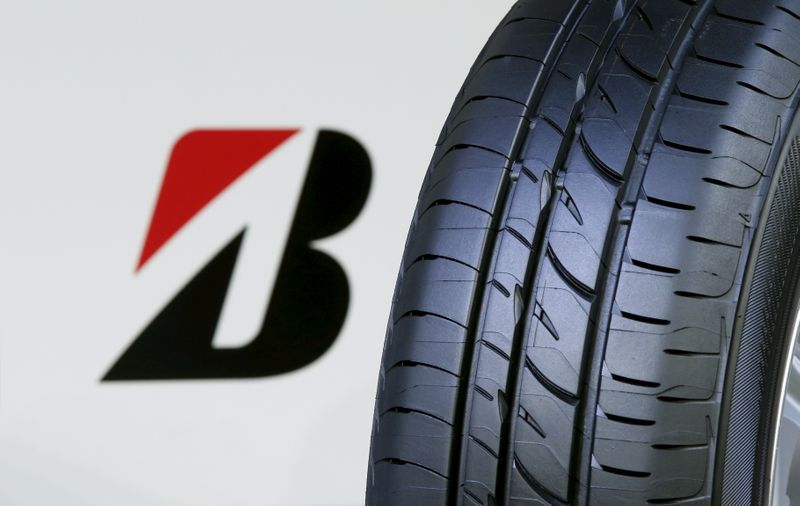 The logo of Bridgestone Corp is seen next to its new Playz tyre during the tyre's unveiling event in Tokyo