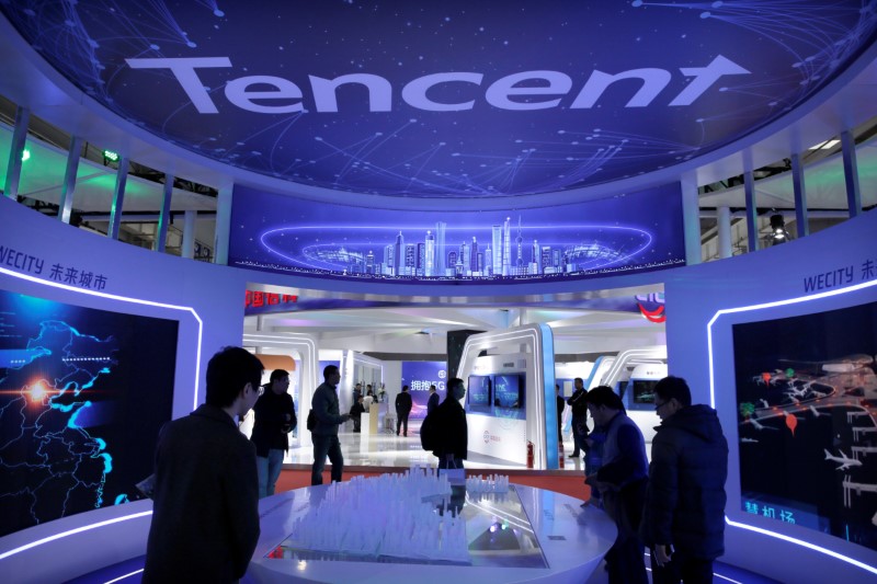 FILE PHOTO: People visit Tencent's booth at the World 5G Exhibition in Beijing