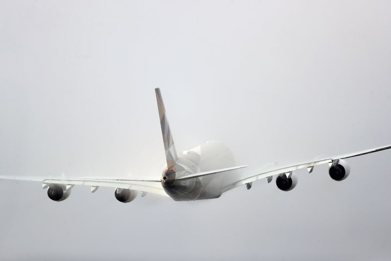 FILE PHOTO: Etihad aircraft disappears into the clouds as it takes off from Heathrow Airport in London