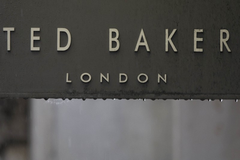 FILE PHOTO: Rain drips off a sign on a Ted Baker sign on a store in London, Britain