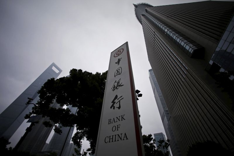 FILE PHOTO: A logo of Bank of China is seen next to skyscrapers at the Pudong financial area in Shanghai