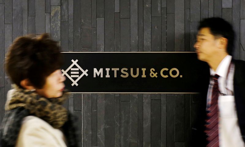 FILE PHOTO: People walk past the logo of Japanese trading company Mitsui & Co in Tokyo