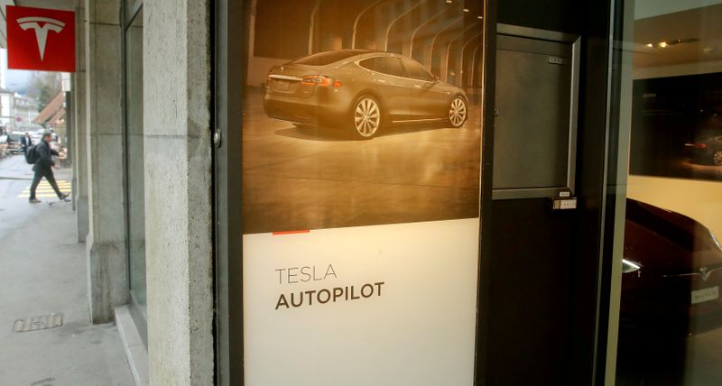 FILE PHOTO: Advertisement promotes Tesla Autopilot at a showroom of U.S. car manufacturer Tesla in Zurich