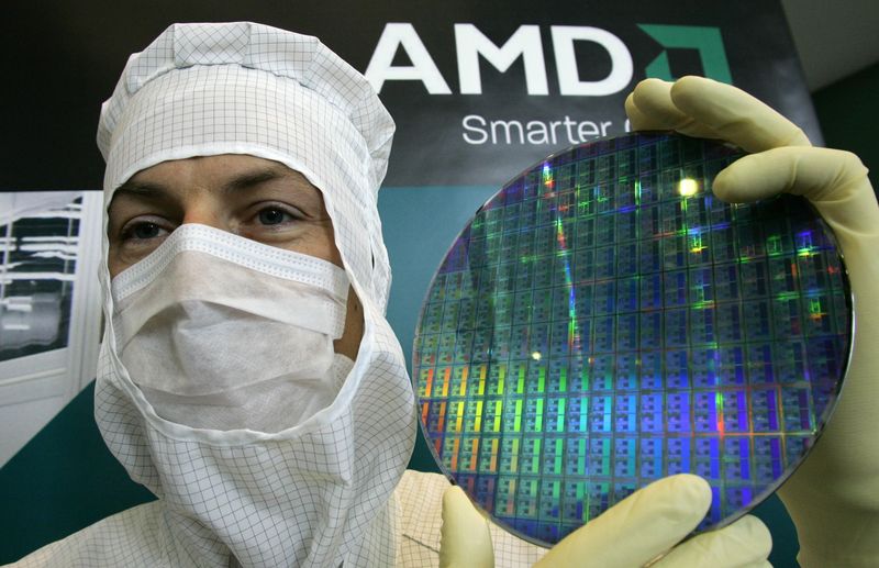 FILE PHOTO: A technician of computer microprocessors maker AMD poses for the media with a wafer at the chip plant in Dresden