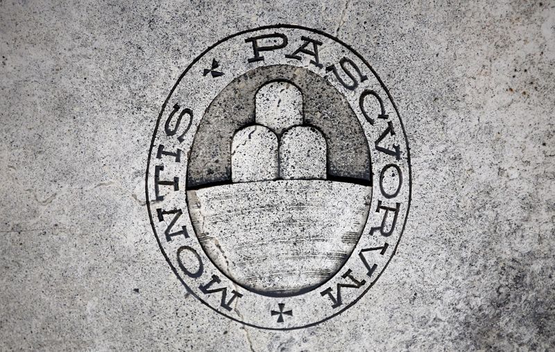 FILE PHOTO: A logo of Monte dei Paschi di Siena bank is seen on the ground in downtown Siena