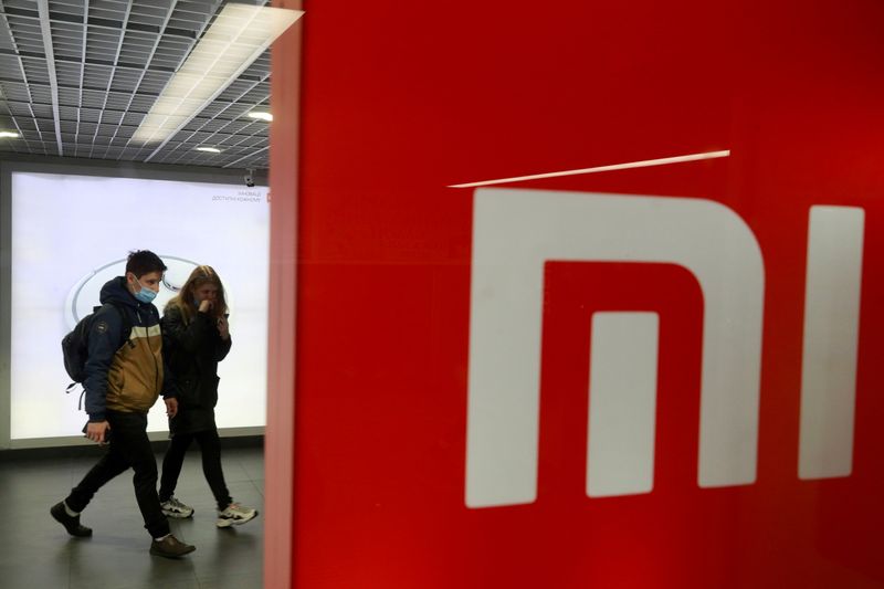 FILE PHOTO: People wearing protective face masks visit Xiaomi brand's store in Kyiv