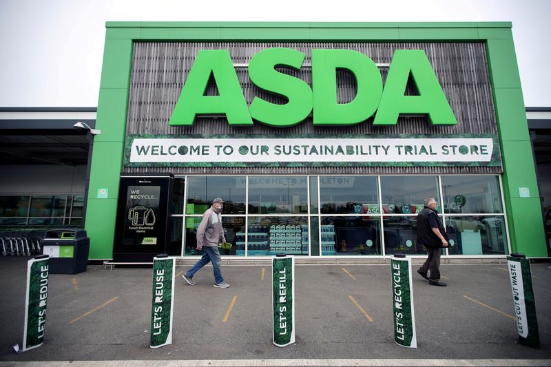 FILE PHOTO: Shoppers walk past the UK supermarket Asda in Leeds