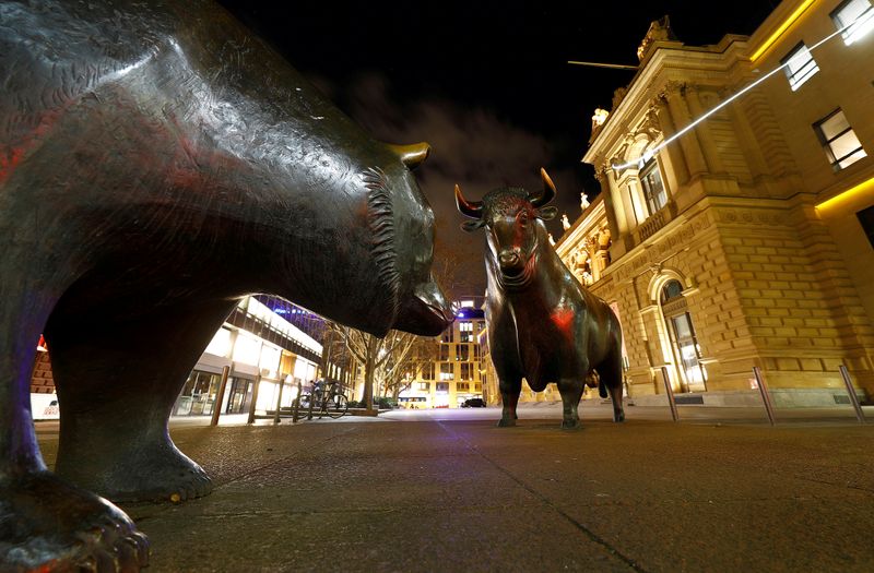 FILE PHOTO: FILE PHOTO: Bull and bear symbols for successful and bad trading are seen in front of the German stock exchange (Deutsche Boerse) in Frankfurt