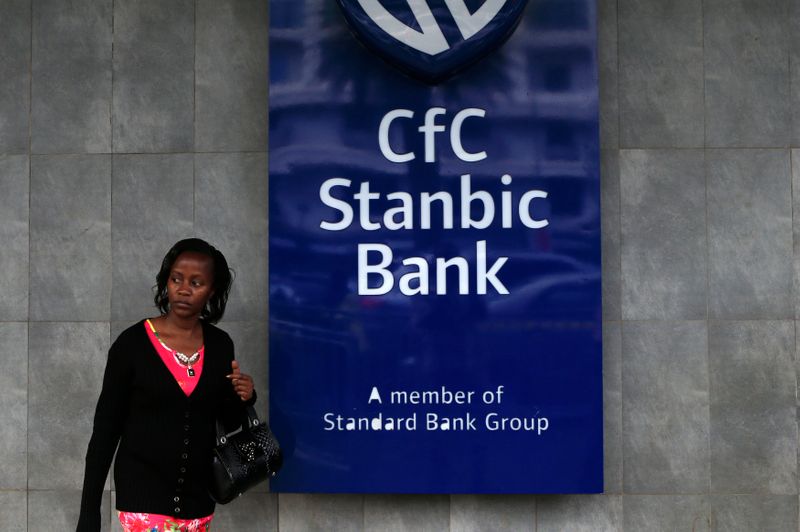 A woman walks near Stanbic Bank branch in Kenya's capital Nairobi