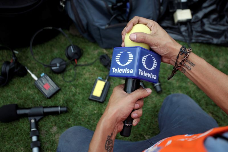A technician holds a microphone of Mexican broadcaster Televisa before a soccer match at Universitario stadium in San Nicolas de los Garza