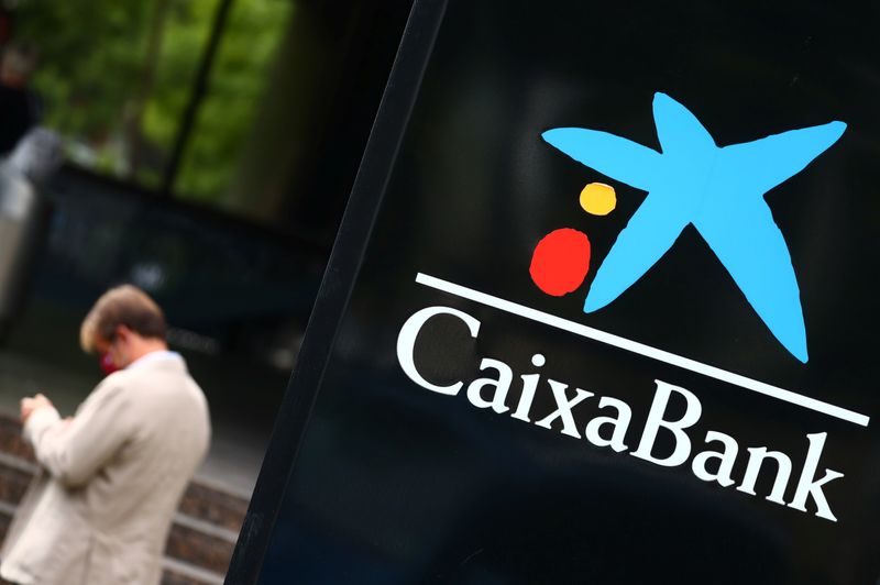 The logo of Caixabank is seen outside a branch in Madrid